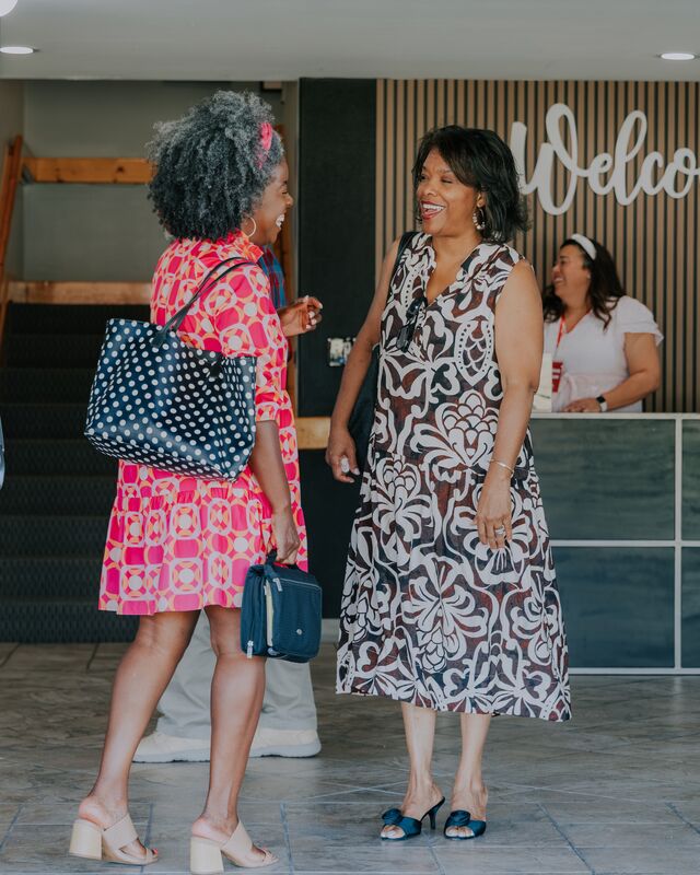 Two women catching up in the lobby after a service
