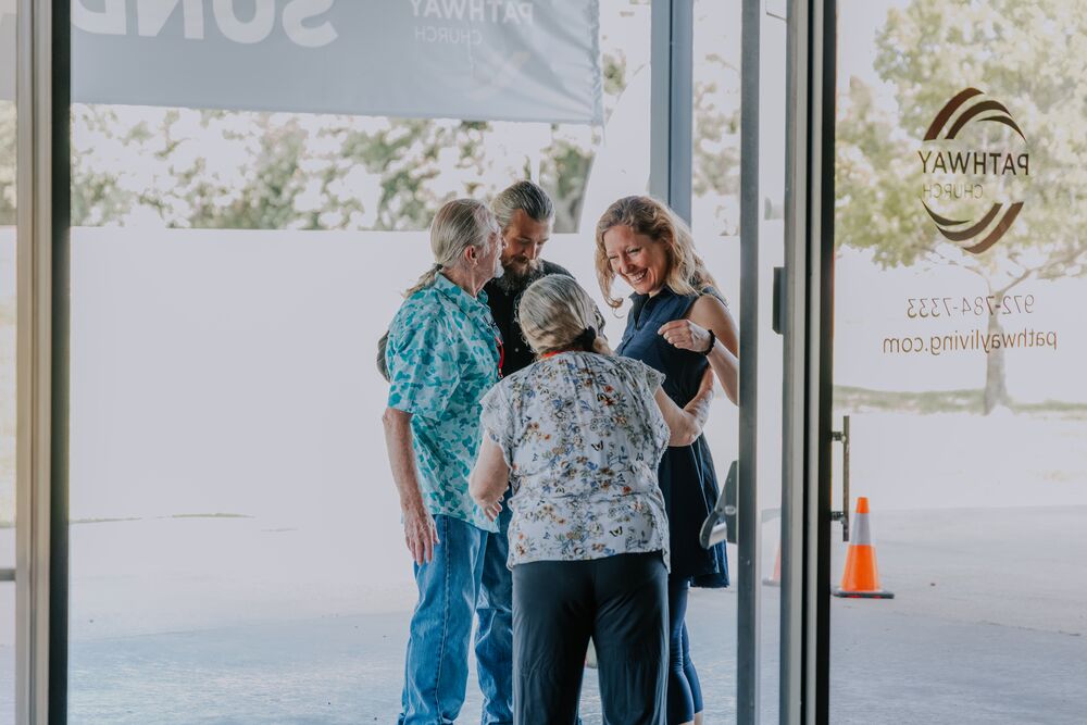 Guests being welcomed at the front doors of Pathway Church